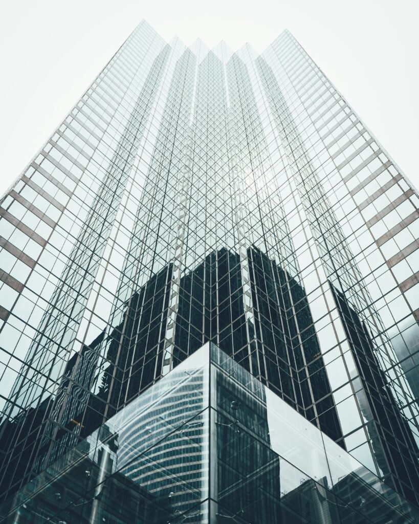 pexels photo 1662159 1662159 Striking low angle view of a modern skyscraper with reflective glass facade in a cityscape.